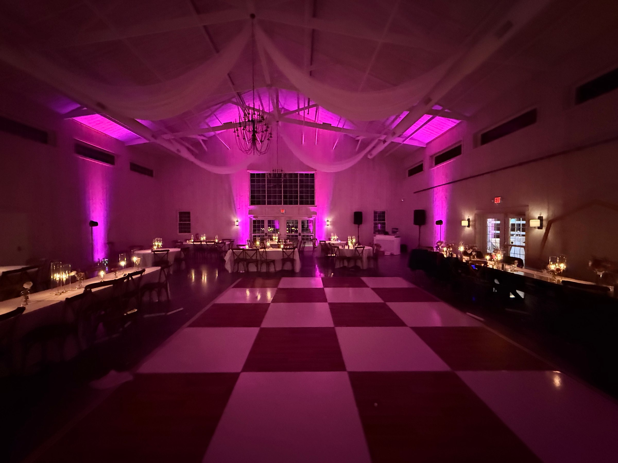 A reception room lit with Sound Decisions wireless uplighting