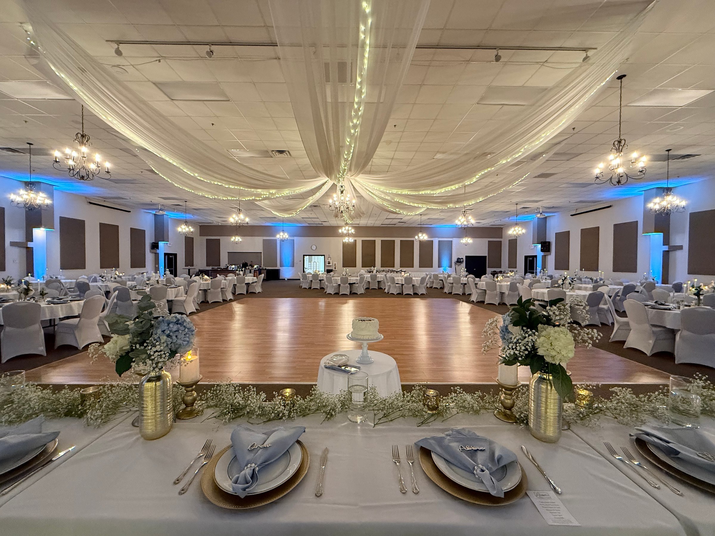 A reception room glowing with Sound Decisions wireless uplighting